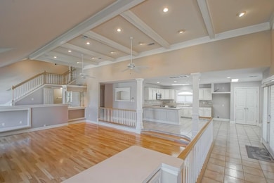 Open floor plan with large living room, high ceili