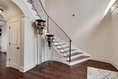 Staircase featuring wood finished floors, visible 