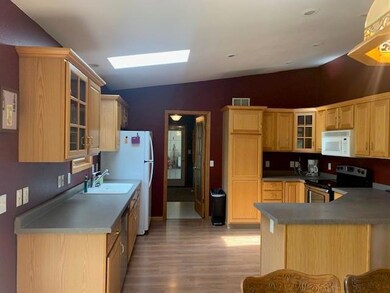 Kitchen leading into main level laundry room.  Mai