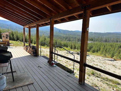 Deck featuring a mountain view and a forest view