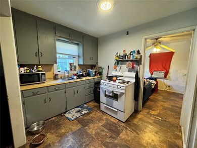 Kitchen featuring white range with gas stovetop, s