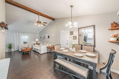 Dining area with lofted ceiling with beams, dark h