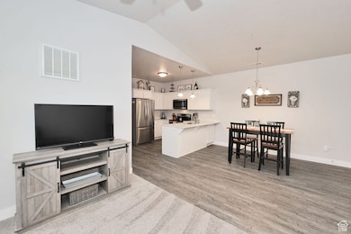 Kitchen and lofted ceiling, a breakfast bar area, with stainless steel appliances