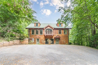 View of front of home featuring a balcony and fence