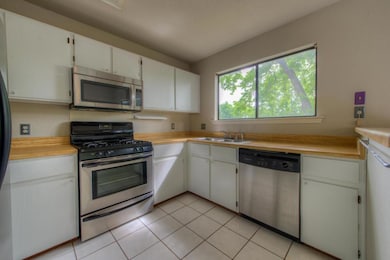 Kitchen with stainless steel appliances, a sink, 