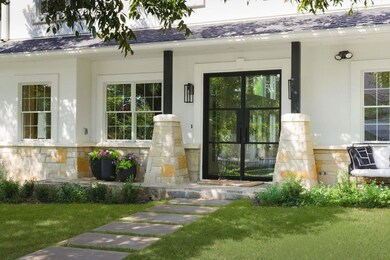 Entrance to property with a lawn, roof with shing