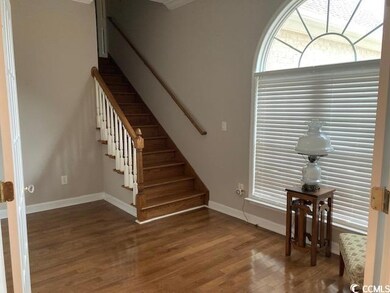 Staircase featuring wood finished floors and baseb