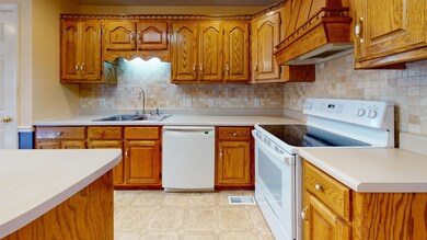 Step into this open kitchen with a tile backsplash.  