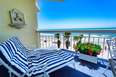 Balcony with view of water and beach