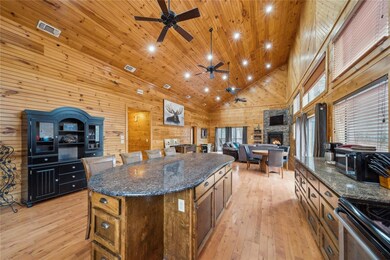 Kitchen featuring wood walls, a center island, hig