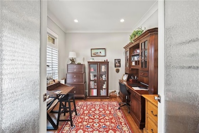 Office space with wood finished floors and recessed lighting