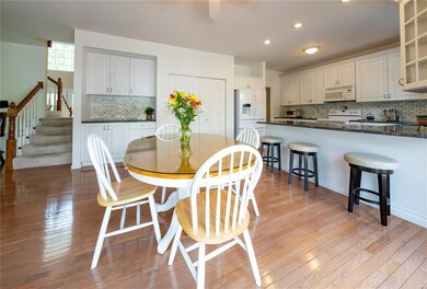 View of T-shaped staircase from kitchen