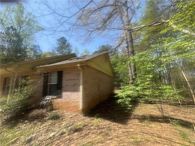 View of property exterior featuring brick siding