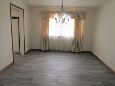 New ceramic tile floor and Edison light chandelier