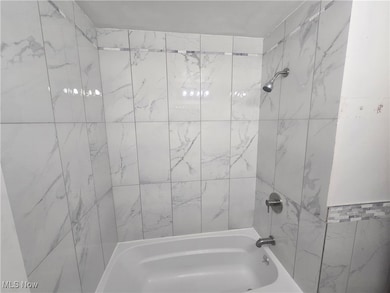 Bathroom featuring shower / washtub combination