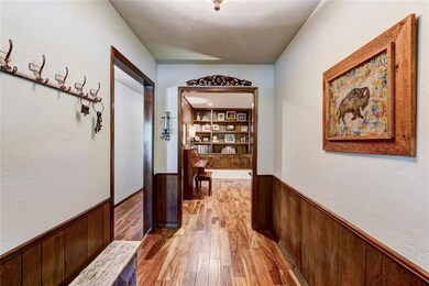 Entry view that shows the direction toward three of the bedrooms and a view of the living area.