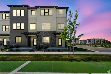 Contemporary home with a front lawn, a standing seam roof, brick siding, and a metal roof