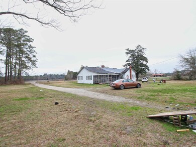 View of yard featuring a sunroom and driveway
