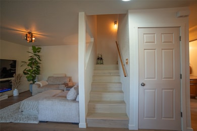 Staircase featuring engineered hardwood.