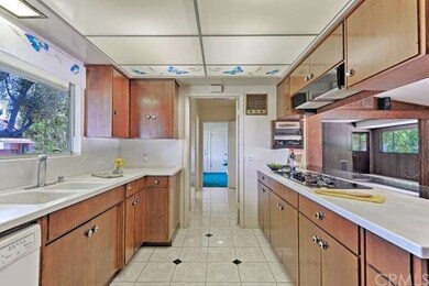 Kitchen with solid surface countertops and tile fl