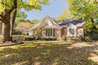 Tudor-style house featuring brick siding