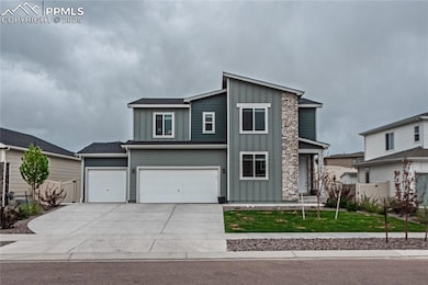 View of front of house featuring board and batten siding, driveway, and an attached garage