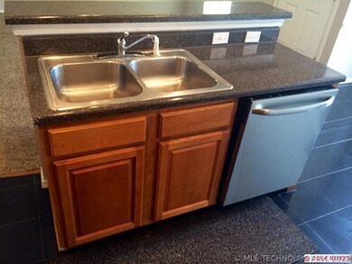 Island with sink and stainless dishwasher.
