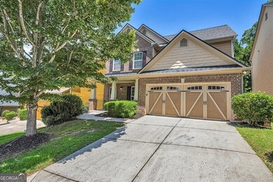 Craftsman-style house with a garage, driveway, brick siding, and roof with shingles