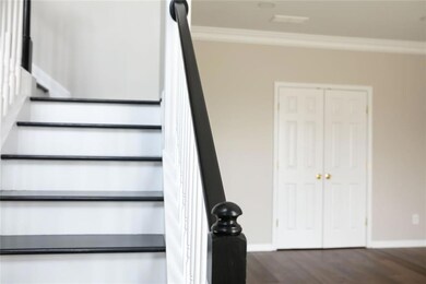 Staircase featuring crown molding, baseboards, and