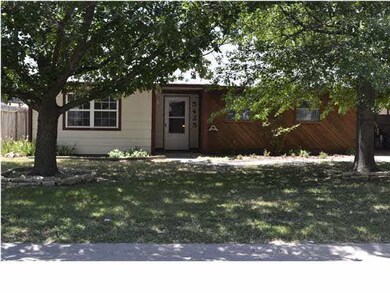 Front view of home between the trees.