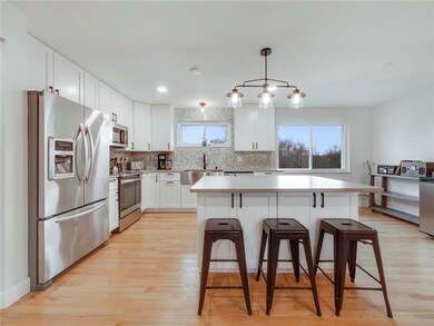 Stainless steel appliances, white shaker style cab