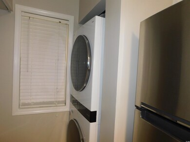 Laundry area featuring stacked washer and clothes dryer