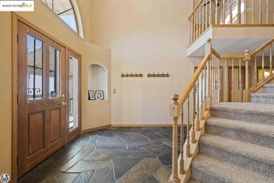 Entryway featuring plenty of natural light and a towering ceiling