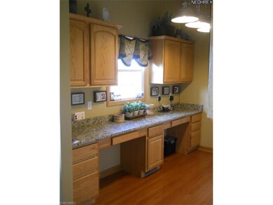 Office work area off the kitchen with oak cabinetr