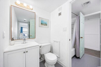 Full bathroom featuring toilet, hardwood / wood-st
