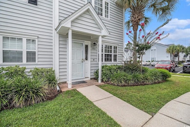 View of exterior entry featuring a lawn