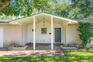 Welcoming covered entry and stunning front door set the tone.
