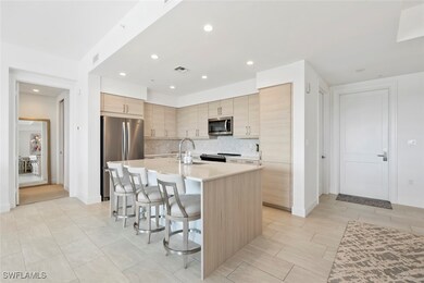 Kitchen with sink, a breakfast bar, appliances wit