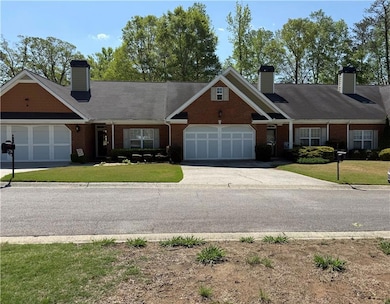 View of front of house featuring a front lawn, bri