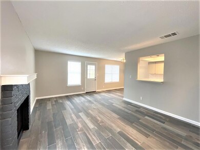 Unfurnished living room with dark wood-style floo