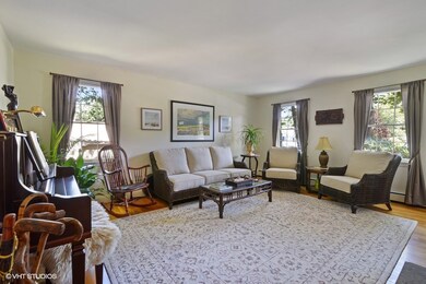 The light and bright living room features hardwood