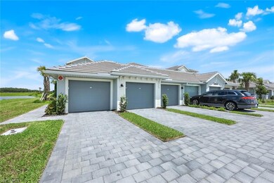 View of front of home featuring decorative driveway, a tiled roof, and a front yard