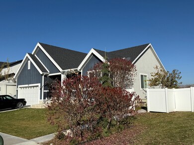 View of side of home featuring roof with shingles and a garage