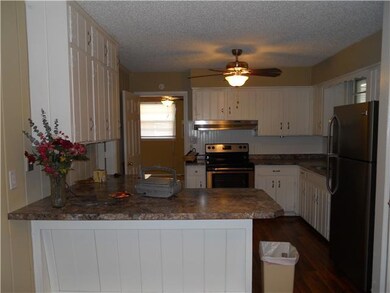 Kitchen With Breakfast Bar and Stainless Steel Appliances and Hardwood Flooring