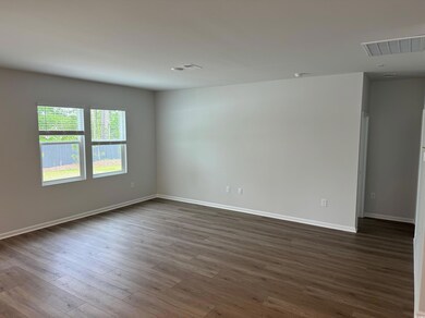 Spare room featuring visible vents, baseboards, an