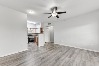 Unfurnished living room featuring ceiling fan, li