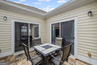 The sliding glass door on the right leads to the dining area, kitchen & family room.  The door on the left opens to a sunroom leading to the primary retreat.