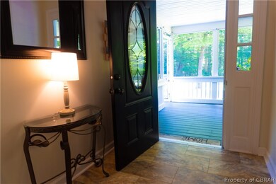 Tiled entryway featuring plenty of natural light