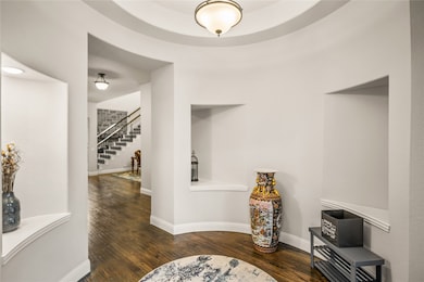 Hallway with dark wood-type flooring and stairway