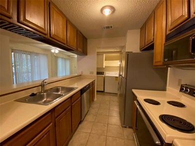 Kitchen featuring stainless steel dishwasher, a s